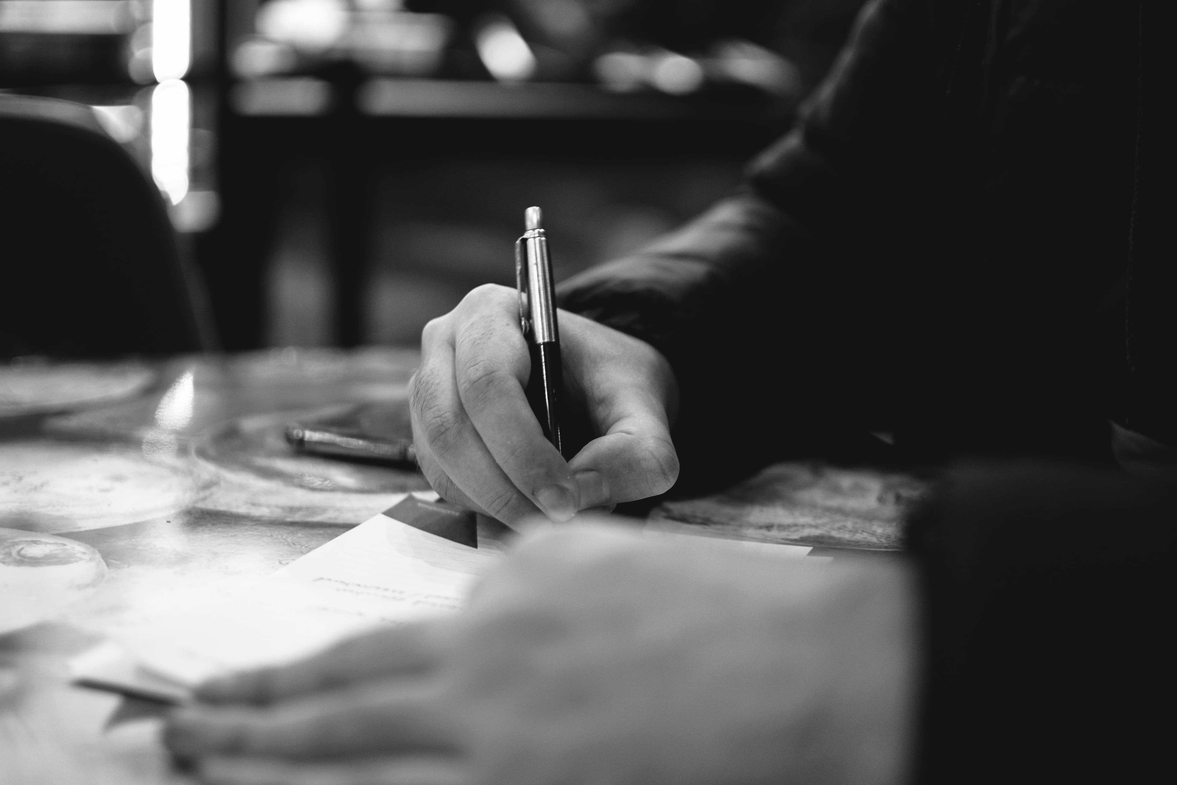 A close-up of someone writing notes during a reflective working session